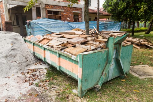 Building exterior near Queens Park with waste collection vehicle in view
