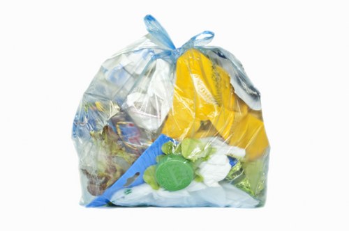 Waste removal team at work in Queens Park with branded truck