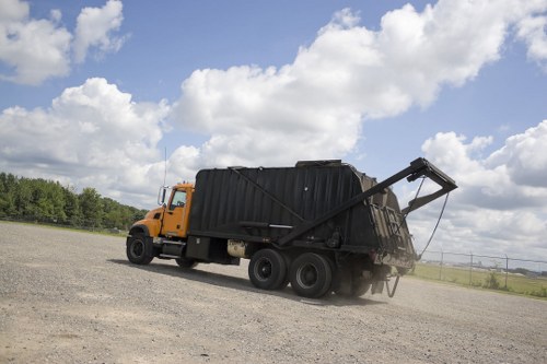 Workers segregating commercial waste into bins for disposal